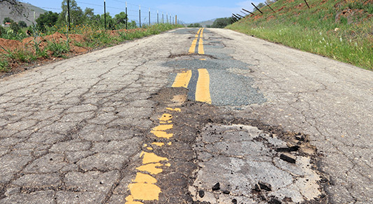 Pot hole on an empty road