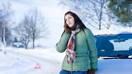 Woman calling for roadside assistance in the winter