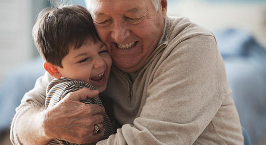 Grandfather hugging his grandson