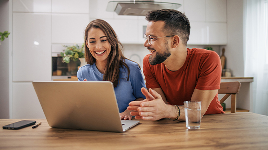 Couple browsing on a laptop