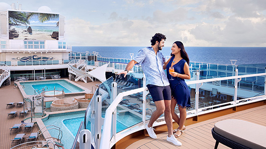 Couple on deck of cruise ship at sea