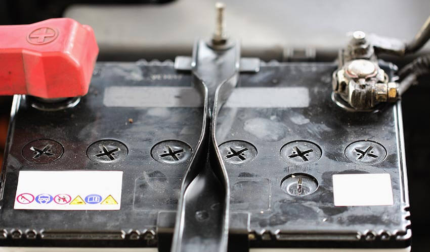 Close up of the top of an old car battery