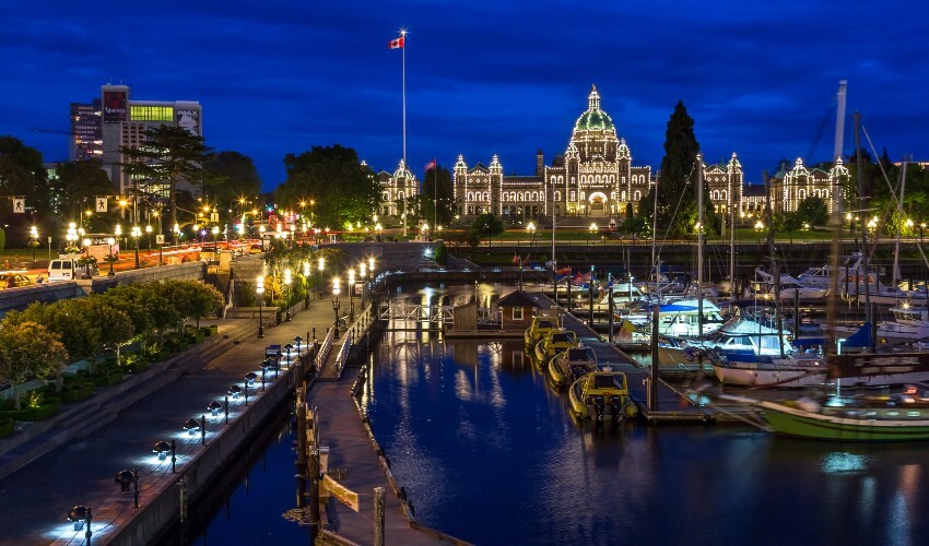 View of the Inner Harbour with B.C. Parliament lit up in the background.