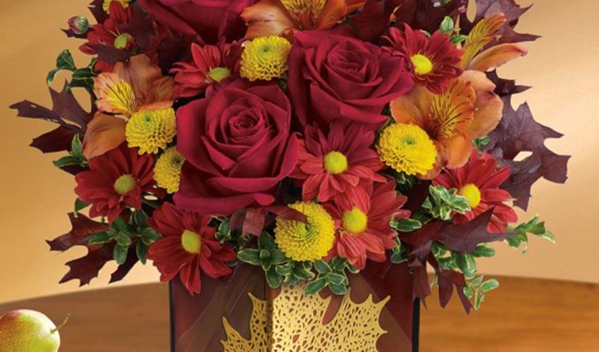 A large bouquet of festive flowers in red and yellow flowers.