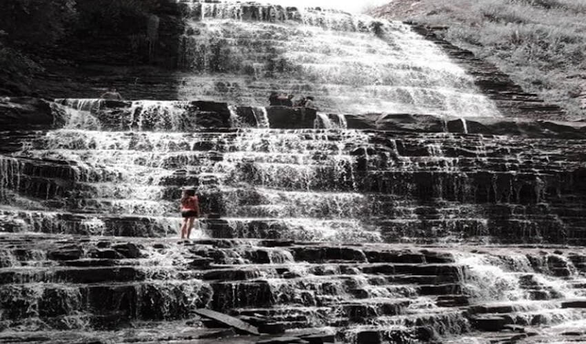 A woman looking at Albion Falls in Hamilton Ontario.