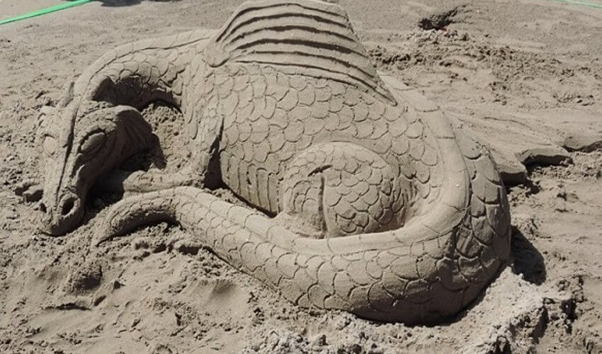 Cobourg beach sand sculpture of a dragon.