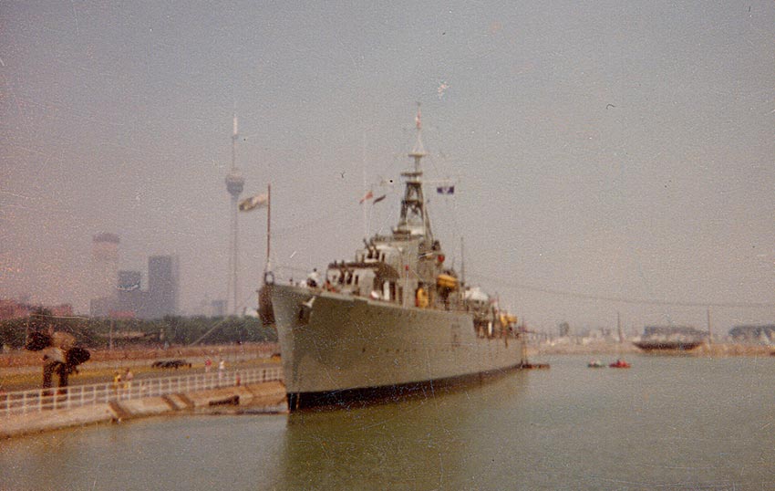 A ship docked in the waterfront with the CN Tower in a distance.