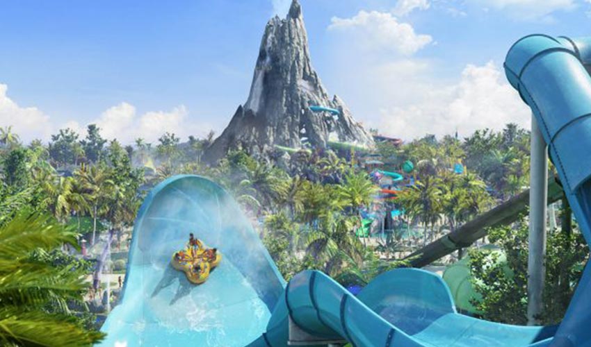 A family of four sliding down Volcano Bay water slide.