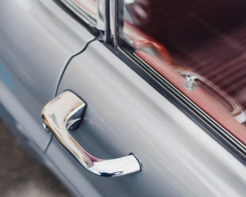 Close up of a sliver car door.