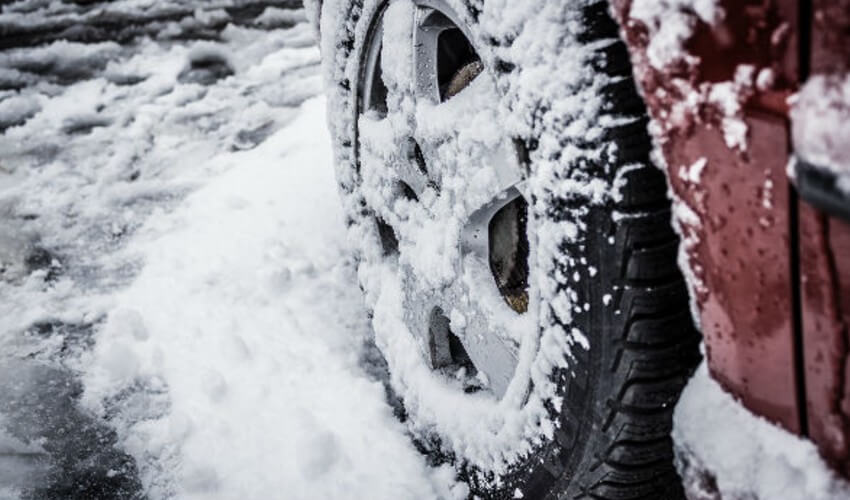Close up of snow on car tires.