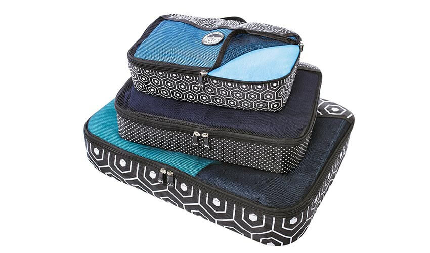 A stack of three blue and black Austin House packing cubes.