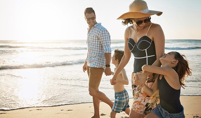 A family walking on a beach.