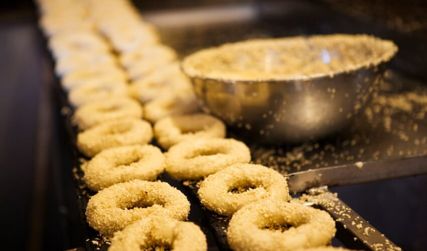 Montreal-style bagels lined up to be baked.