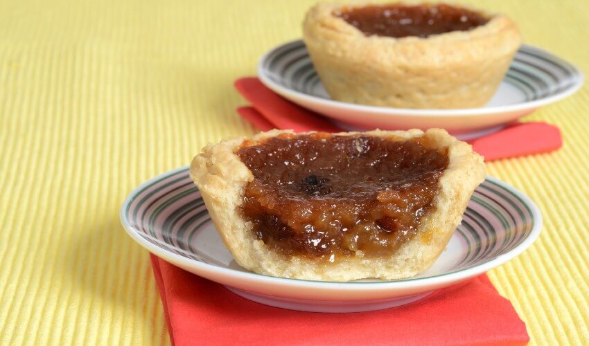 Two delicious butter tarts on the table.