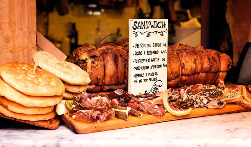 Delicious porchetta and other savories along a street in Rome.