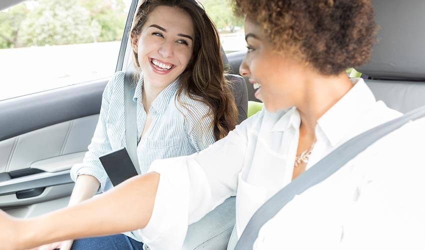 Two women in a car going on a road trip.