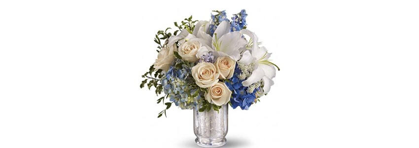 A bouquet if beige roses and delphinium flowers