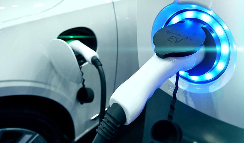 An electric vehicle charger with blue LEDs around the port.