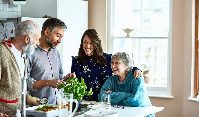 Family gathering in a kitchen, preparing food.