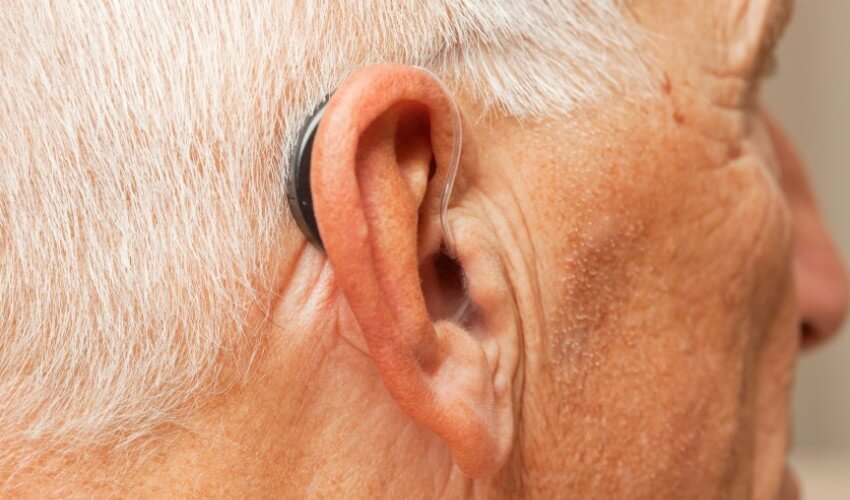 Close up of senior wearing a hearing aid.