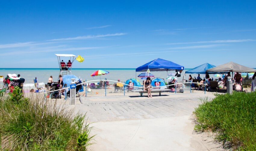 People and lifeguards enjoying a day at Grand Bend Beach, Ontario.