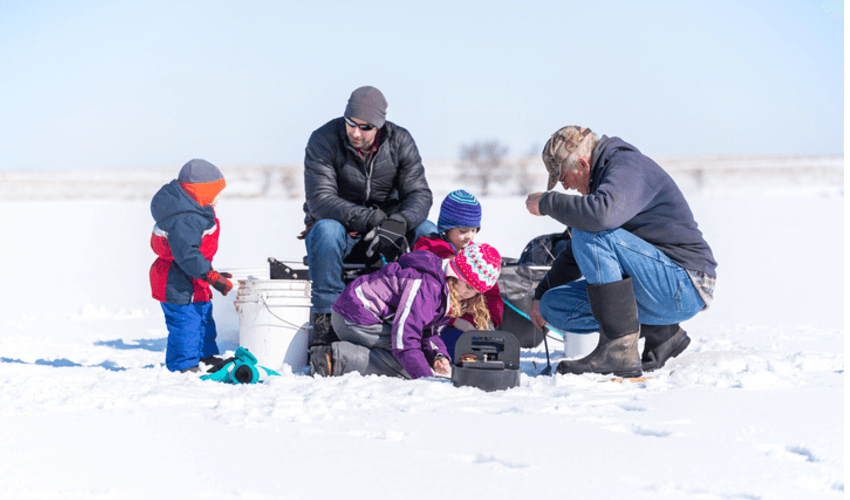 Family ice fishing on a late winter day.