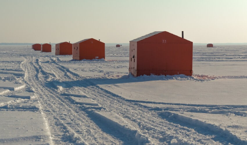 Ice fishing huts on a frozen lake in Ontario.