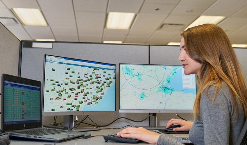 A CAA employee looking at a computer screen displaying the Gen 2 system.