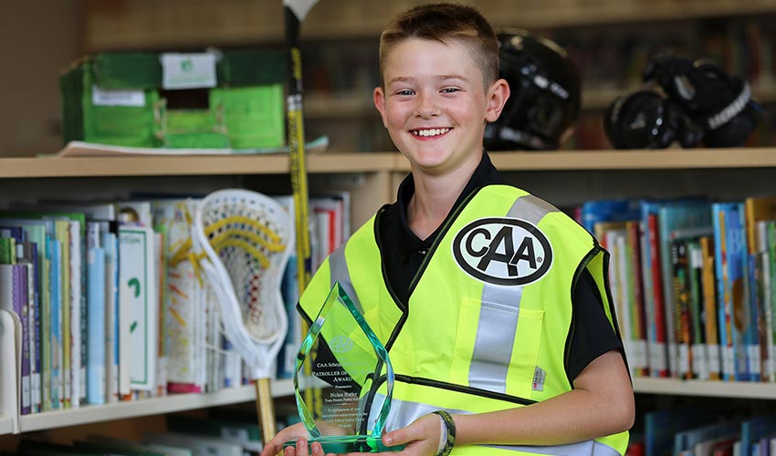 CAA School Safety Patroller, Nolan Butler holding an award.