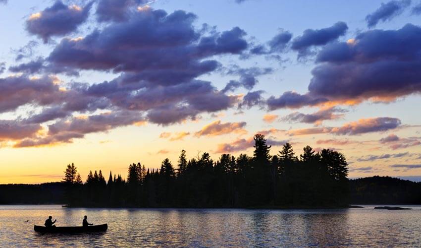 Canoeing on a quiet lake in Algonquin Provincial Park.