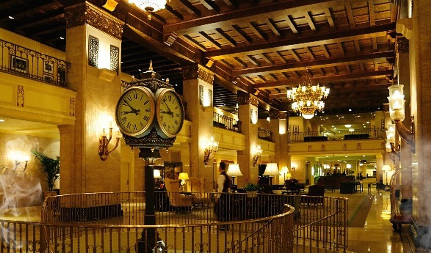Inside Fairmont Royal York Hotel with a large clock on display.