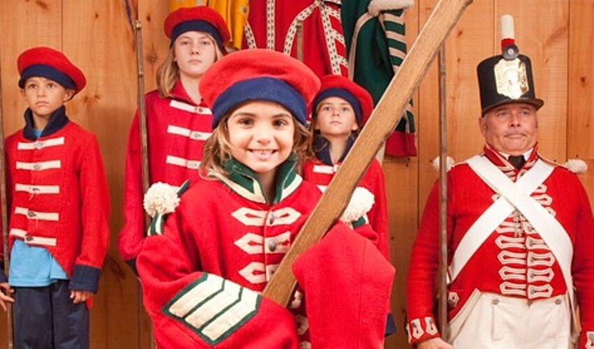 Kids dressed up like soldiers from the past.