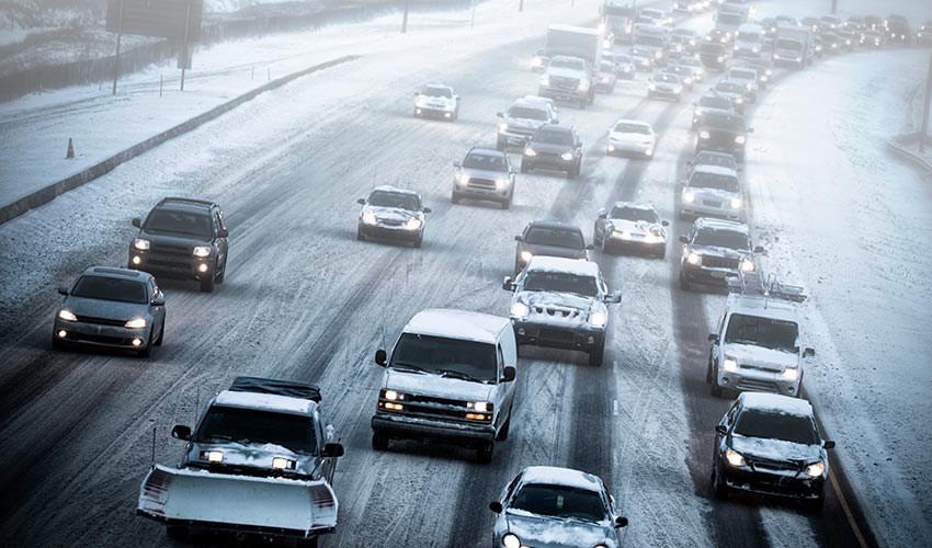 a lot of cars on a busy highway during winter.