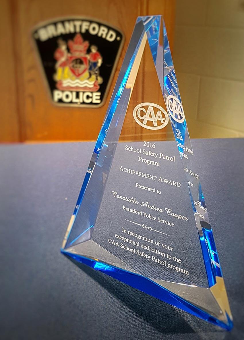 The School Safety Patrol Program Achievement Award placed on a table in front of Brantford Police logo.