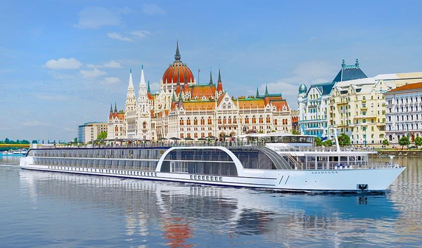 The AmaMagna river cruise ship sailing along Budapest with a view of local architecture. 