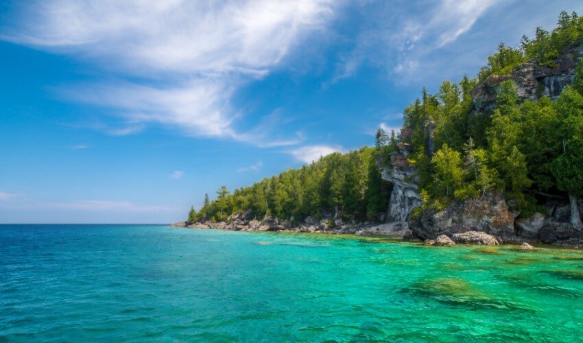 Scenic view of blue water against sky, Tobermory, Canada.