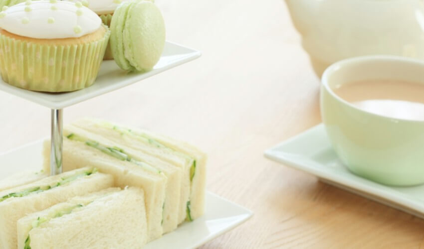Green themed high tea on a wooden table