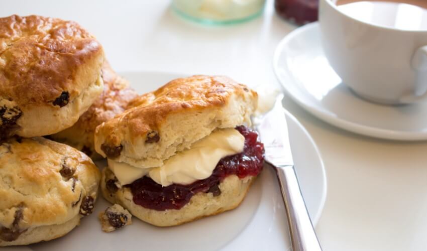 Scones with jam and tea on the side.