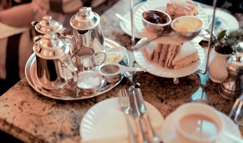 Traditional English breakfast with tea and sandwiches.