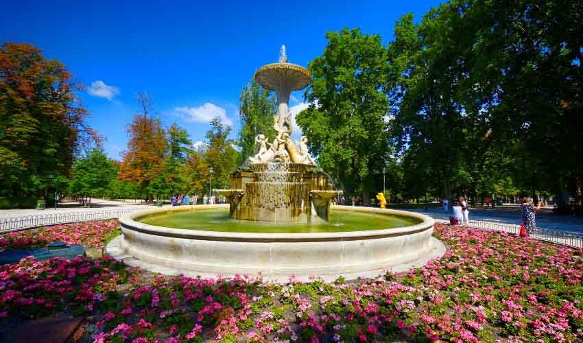 Fountain and flower garden at El Retiro Park in Madrid.