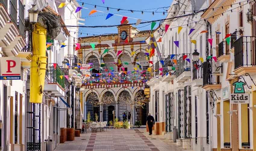 Colourful flags decorate the streets of old town Moguer in Huelva, Spain, during a local festivity.