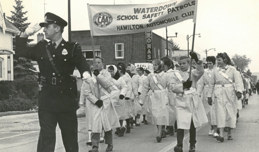 Historic photo of Hamilton School Safety Patrollers marching down the street.