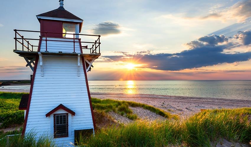 Covehead Harbour Lighthouse with sunset in background.