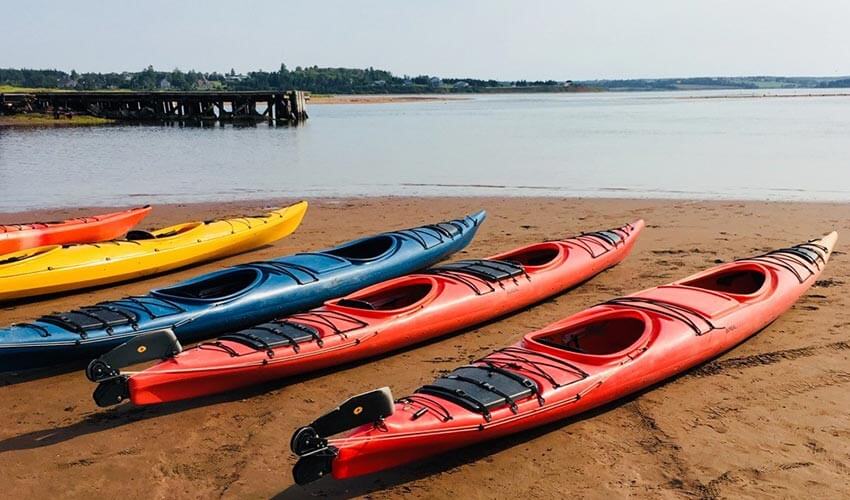 Colourful kayaks on a beach in Prince Edward Island.