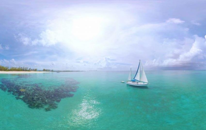 Aerial view of a sail boat on turquoise coloured waters  at Rose Island.
