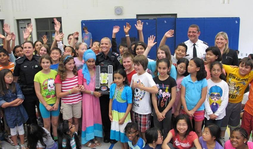 Urmish Shaikh from Vista Heights Public School and their students in a group photo.