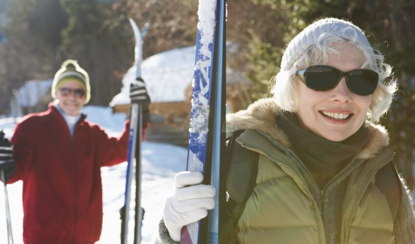 Elderly couple skiing.