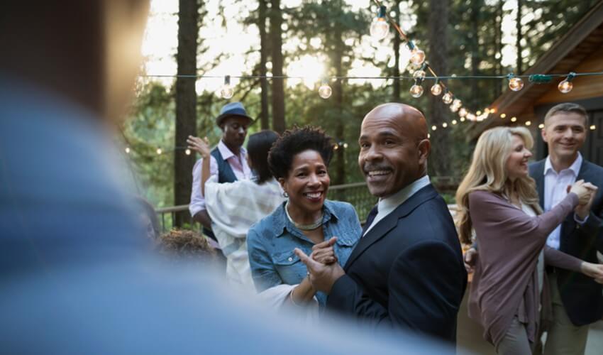 Senior couples dancing at an outdoor party.