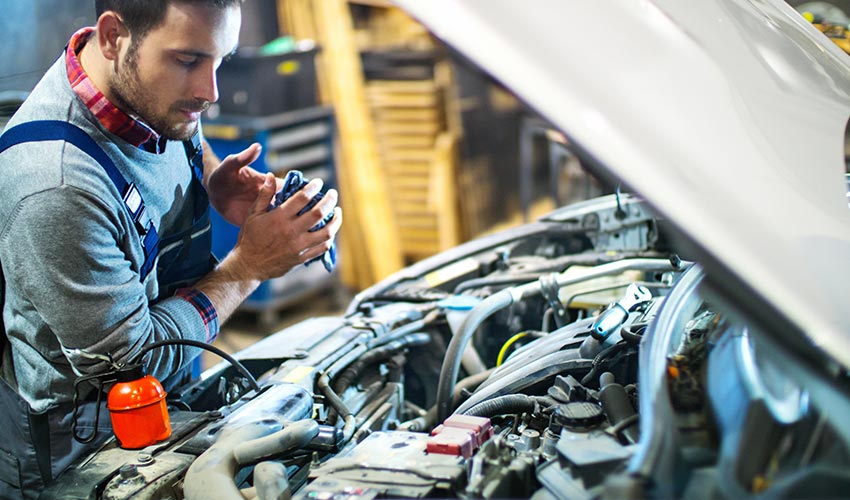 A mechanic working on a car