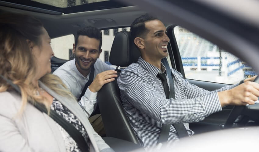 Three friends sitting in a car.